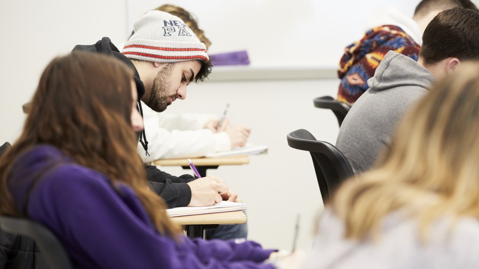 Students take notes in a classroom