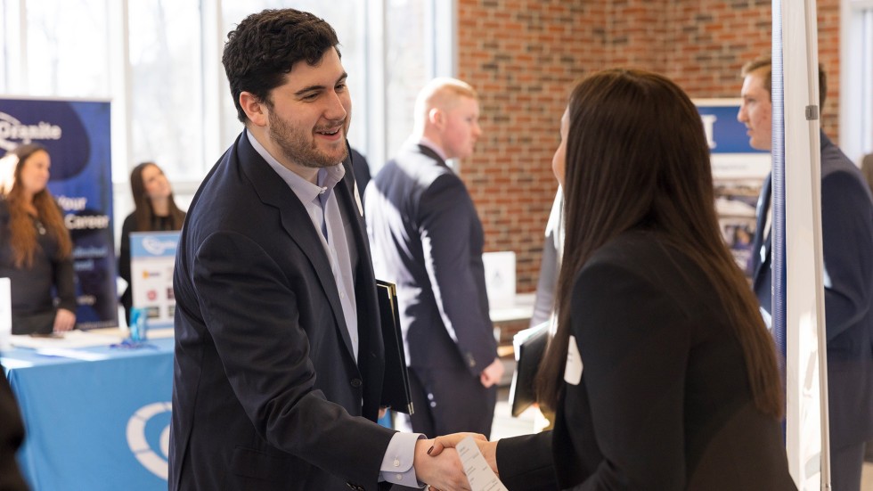 Student talking to human resources representative at a company