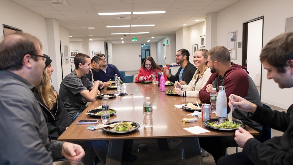 Graduate students eat lunch together