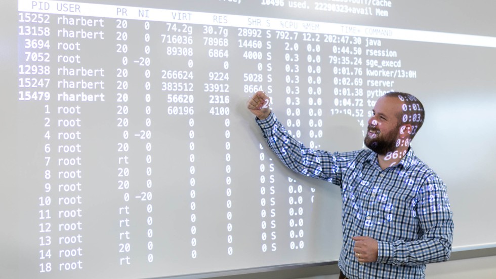 Student stands at board to examine data