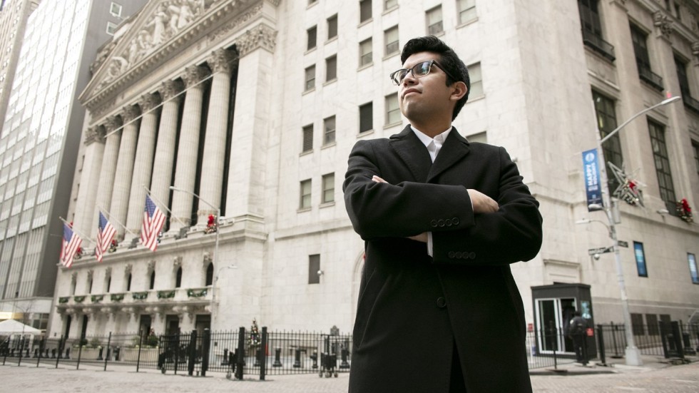 Eric Dominguez standing outside in New York City where he works on Wall Street