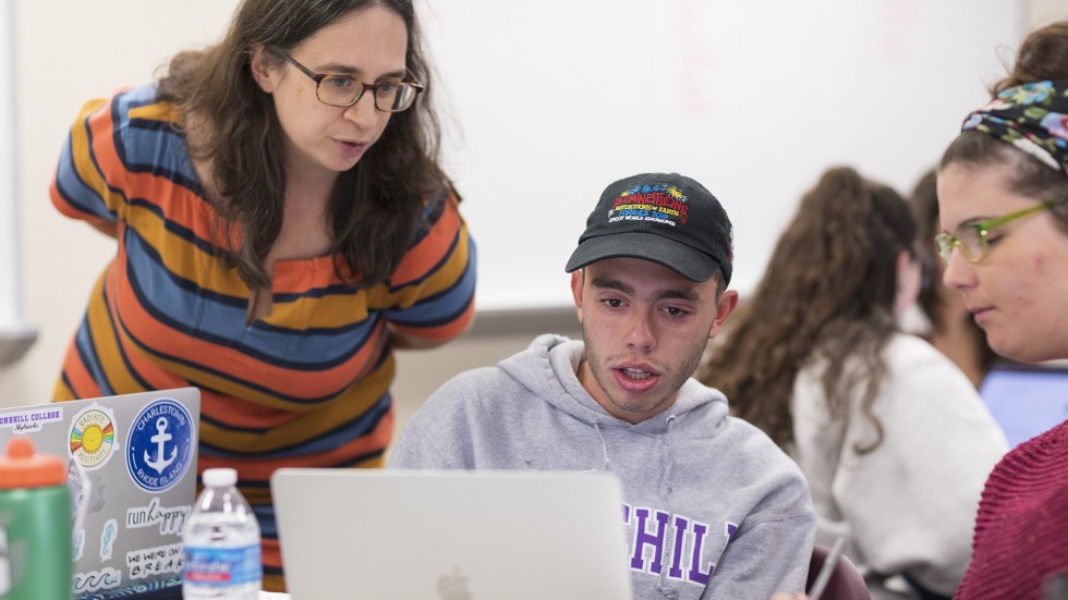 Professor working with student in class