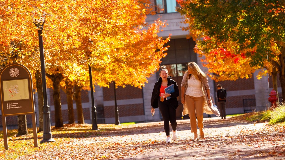 Professor with student on campus in the fall