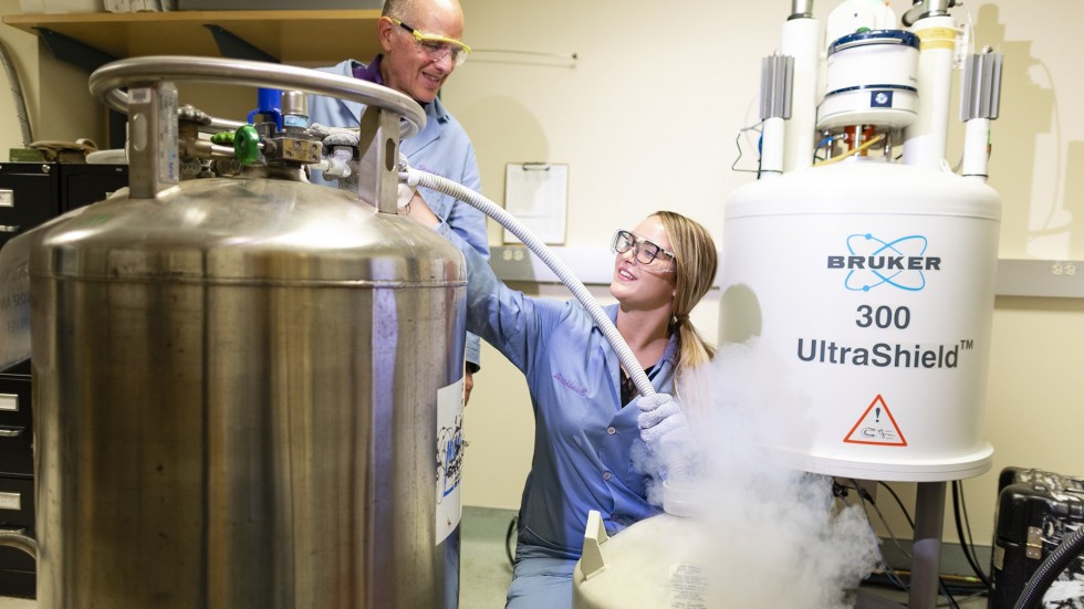 Student works with professor on NMR Machine