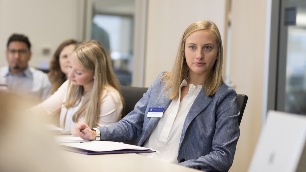 Student in a board room during an externship program