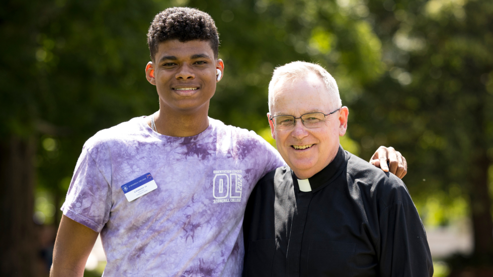 Rev. John Denning, C.S.C. with student