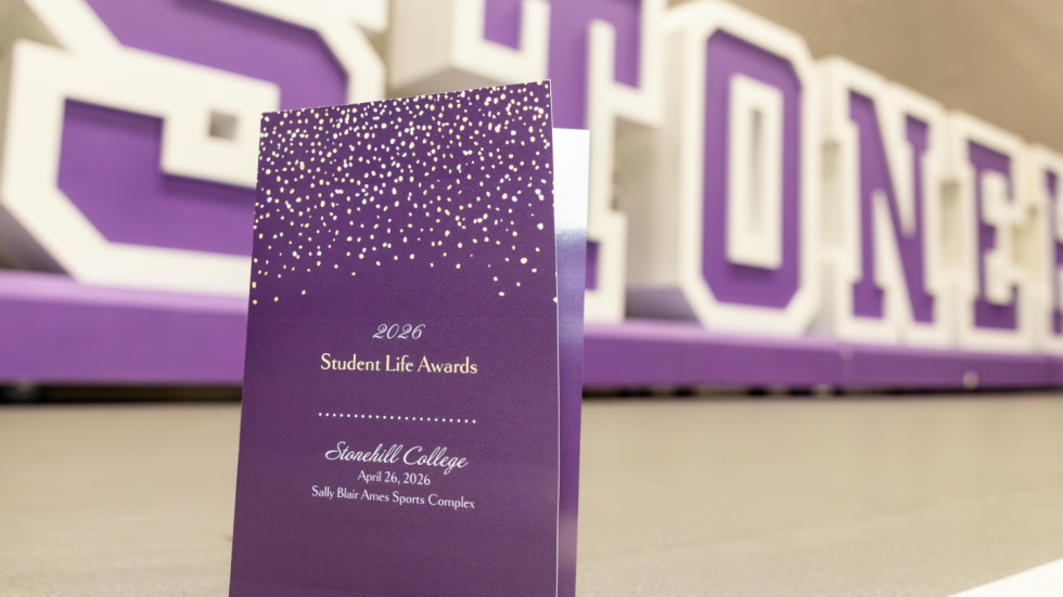Student Life Awards program in front of giant letters that spell out Stonehill.