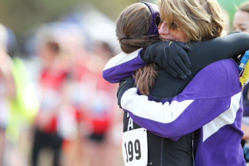 Coach Karen Boen hugs athlete.