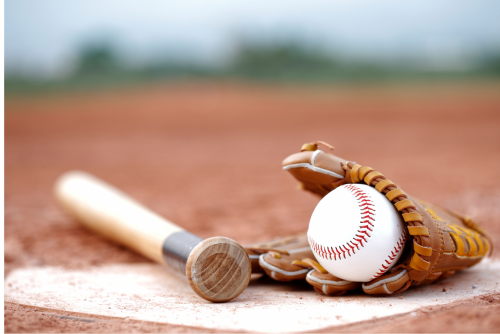 Baseball bat, glove and ball on ground near base