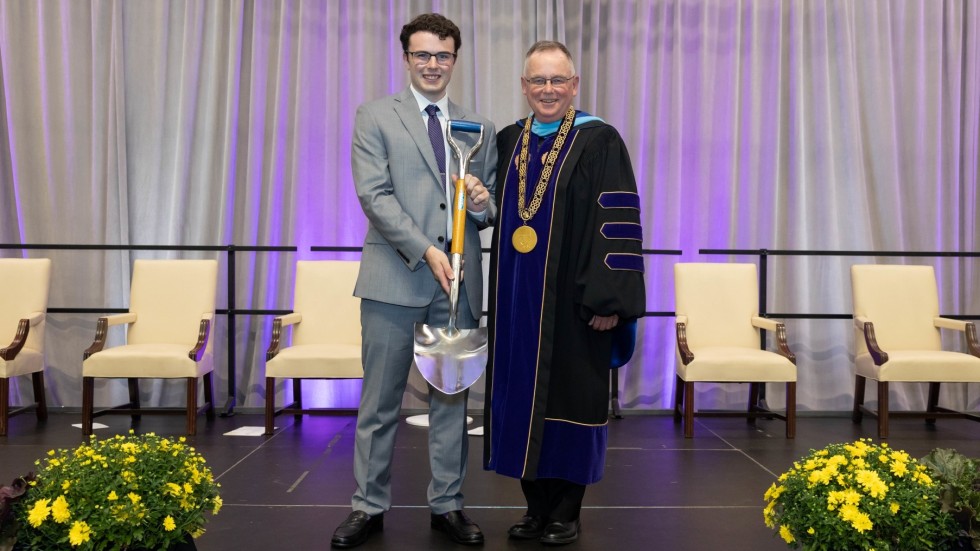 President John Denning, C.S.C., with Andrew Parker '24, holding Ames Shovel.