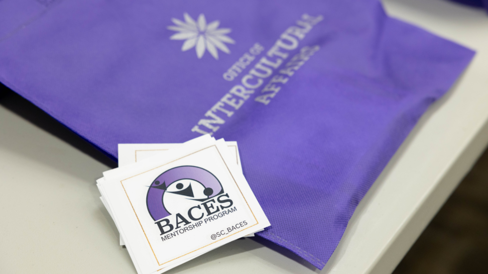 BACES placard and Intercultural Affairs canvas bag