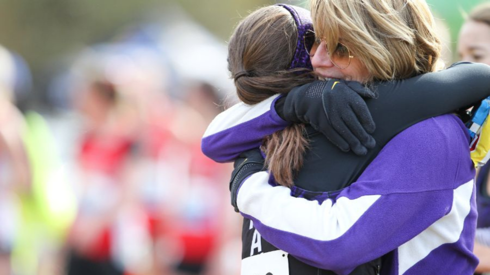 Coach Karen Boen hugs athlete.