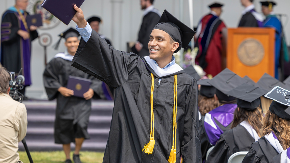 Graduate holding diploma in air