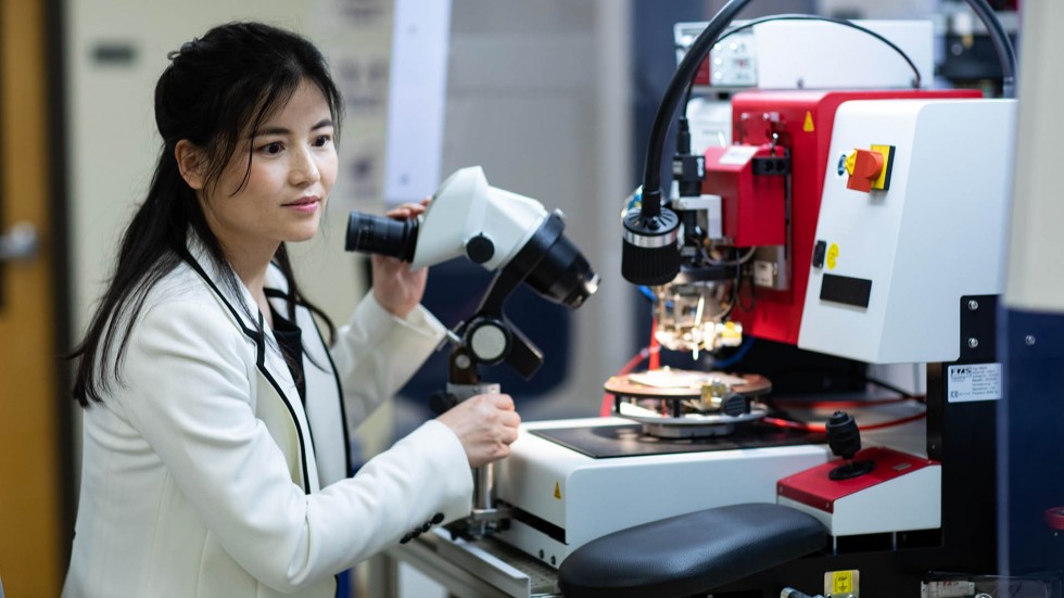 Photo of Professor Ruby Gu using microscope