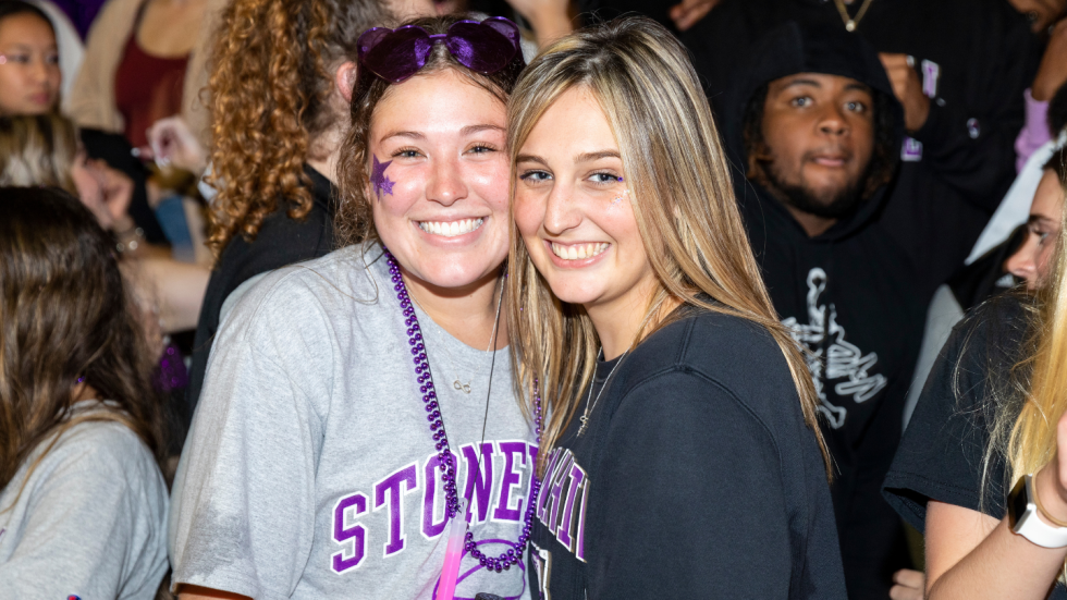 Two students posing for photo at Skyhawk Madness