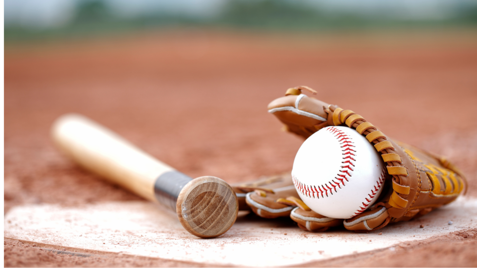 Baseball bat, glove and ball on ground near base
