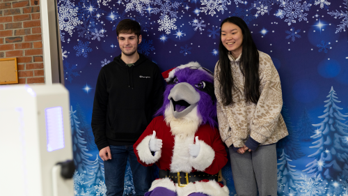 Students taking photos with Santa Ace