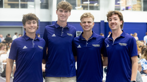 Four members of cross country team in Sports Complex.