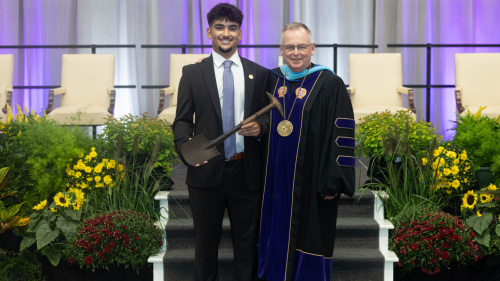Senior Class President Guilherme Vaz ’25 and President John Denning, C.S.C.