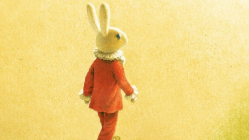 Rabbit in red suit set against yellow background.