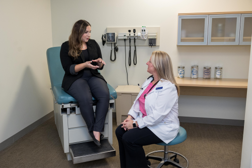 Employee Health & Wellness Coordinator Monique Avila, MSN, FNP-C, offers medical advice to Human Resources Coordinator Stephanie Camillo.