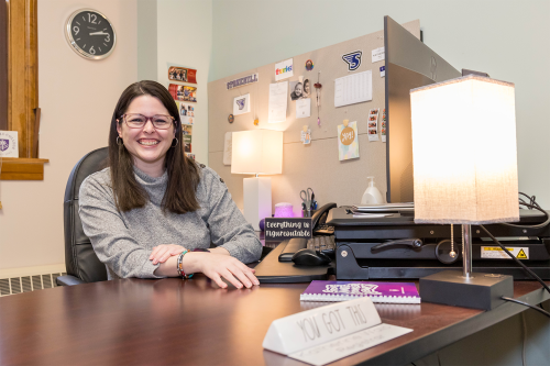 Katie Walo sitting at her desk.