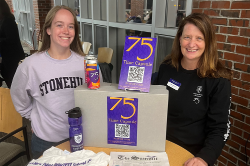 Katie Turner (left) and Nicole (Tourangeau) Casper ’95 (right) manage the Time Capsule voting station at Stonehill College's 75th Anniversary Celebration on September 29, 2023.