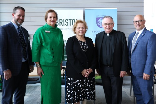 L to R: VP for Academic Affairs at Bristol Community College Andrew Fisher (Bristol), President Laura Douglas (Bristol), Board Chair Joan Medeiros, President John Denning, C.S.C. (Stonehill), VP for Academic Affairs Peter Ubertaccio