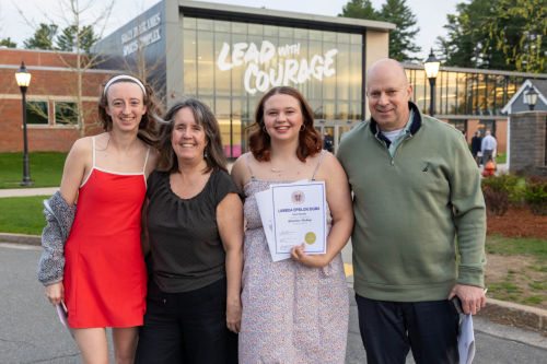 Lambda Epsilon Sigma inductee Genevieve Dockrey (center) joins her family outside the Sally Blair Ames Sports Complex.
