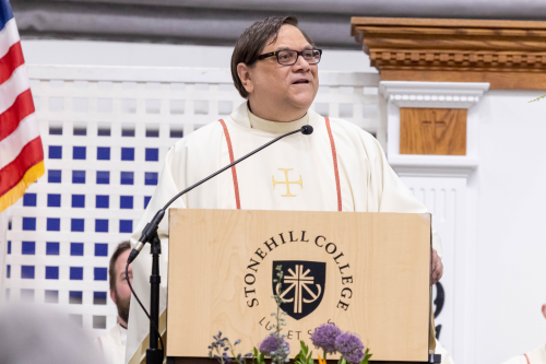 Fr. George Piggford behind podium during Mass.