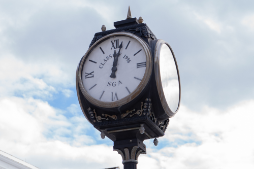 Clock on the quad during daytime.