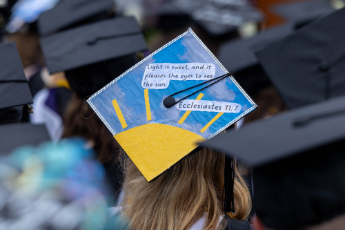 Commencement hat with image of Sun against sky, with quote from Ecclesiastes 11:7 - "Light is sweet, and it pleases the eyes to see the sun."