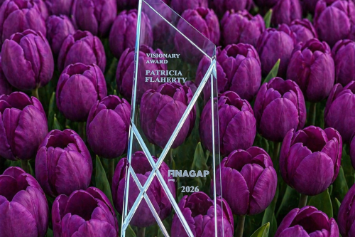 Visionary Award for Patricia Flaherty in front of tulips.