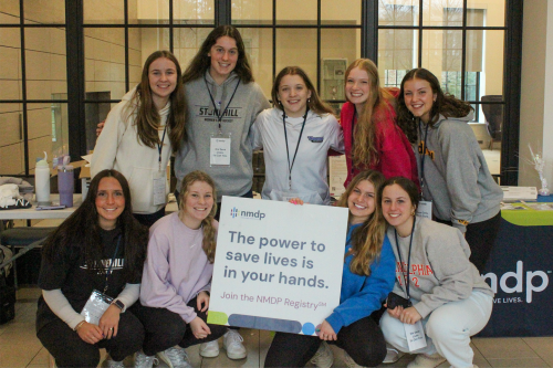 Members of the women's ice hockey team pose for a photo during a recent donor registry event held in Meehan Hall.