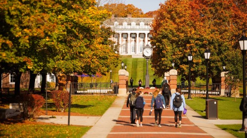 Students walking toward Donahue Hall in the fall.