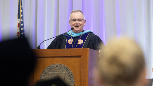 President John Denning, C.S.C., at podium