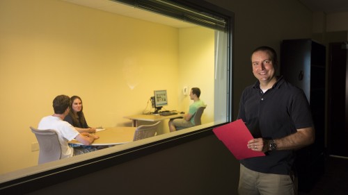Photo of Christopher Poirier and students doing research