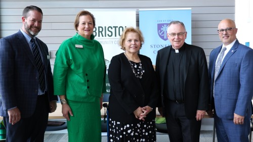 L to R: VP for Academic Affairs at Bristol Community College Andrew Fisher (Bristol), President Laura Douglas (Bristol), Board Chair Joan Medeiros, President John Denning, C.S.C. (Stonehill), VP for Academic Affairs Peter Ubertaccio