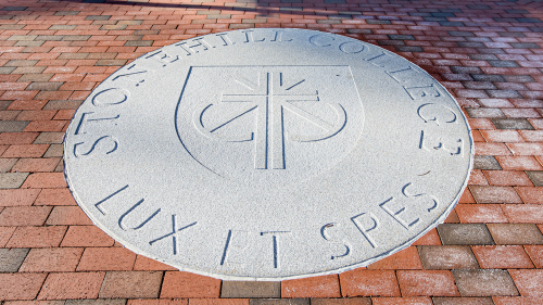 Stonehill College seal etched in stone.