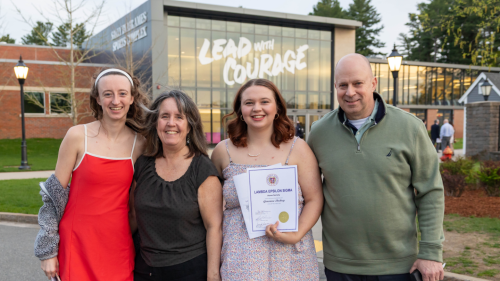Lambda Epsilon Sigma inductee Genevieve Dockrey (center) joins her family outside the Sally Blair Ames Sports Complex.
