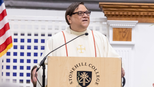 Fr. George Piggford behind podium during Mass.
