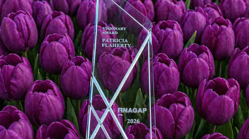 Visionary Award for Patricia Flaherty in front of tulips.