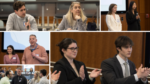 A business meeting is taking place with participants engaged in discussion, presentations, and applause.