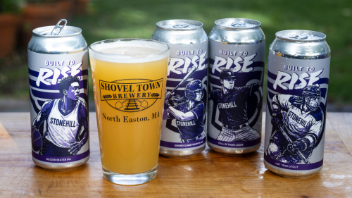 Built to Rise beer cans and beer glass with Shovel Town logo on it.