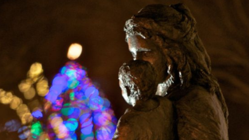 Statue of Mary and Child in front of Chapel of Mary; twinkle lights shine near them.