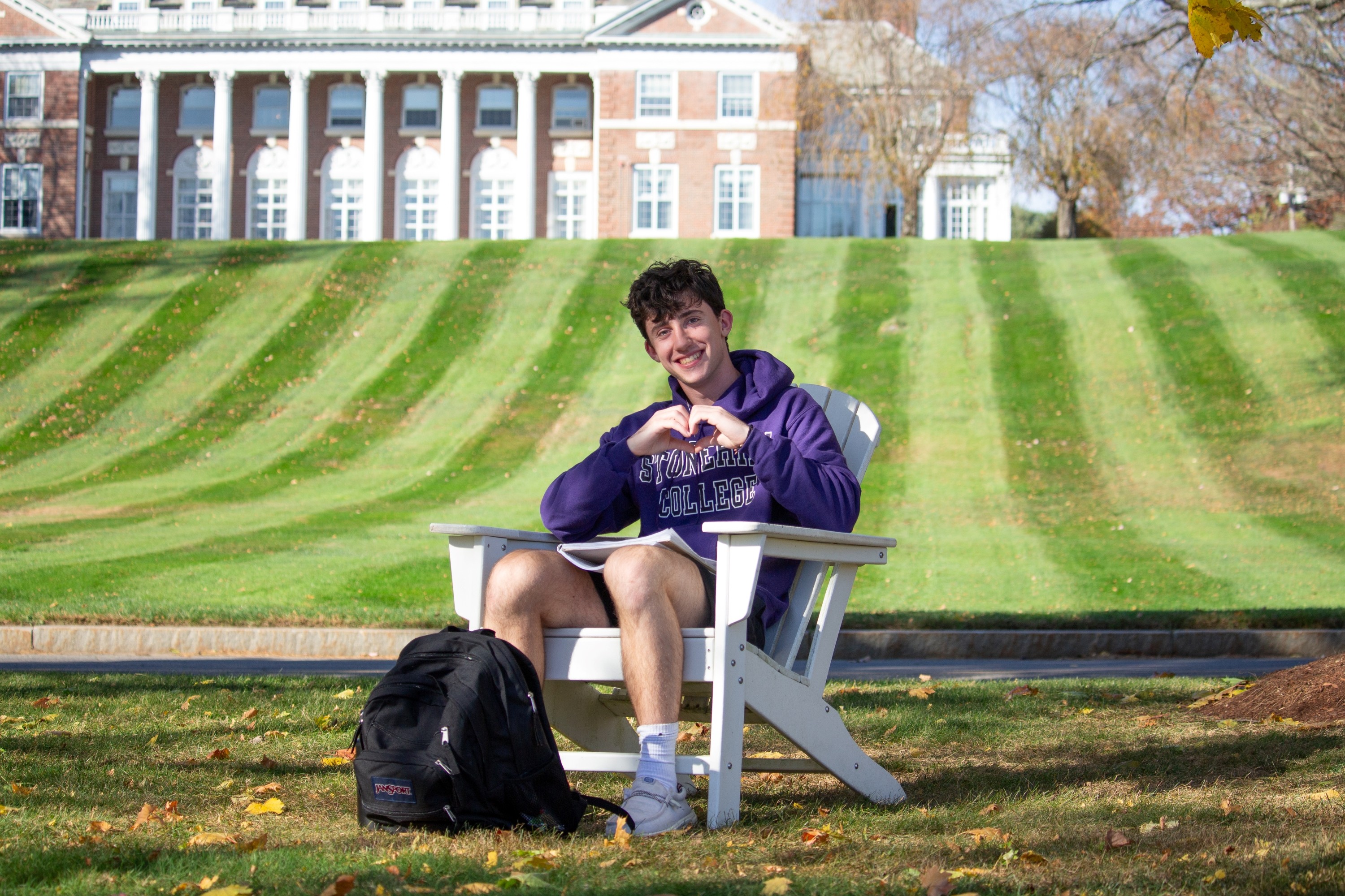 Student in chair in front of Donahue hill