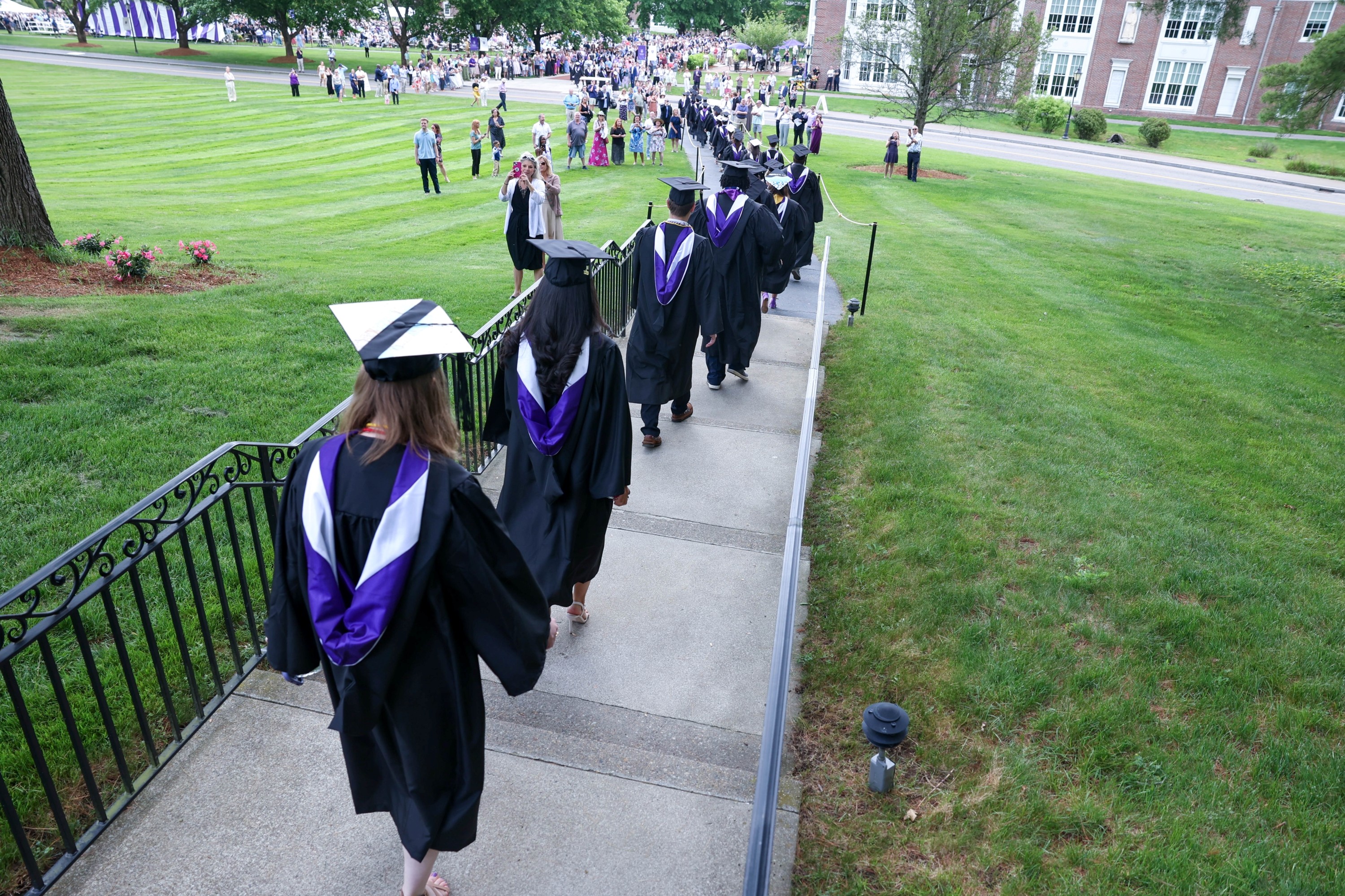 graduates walking down the hill