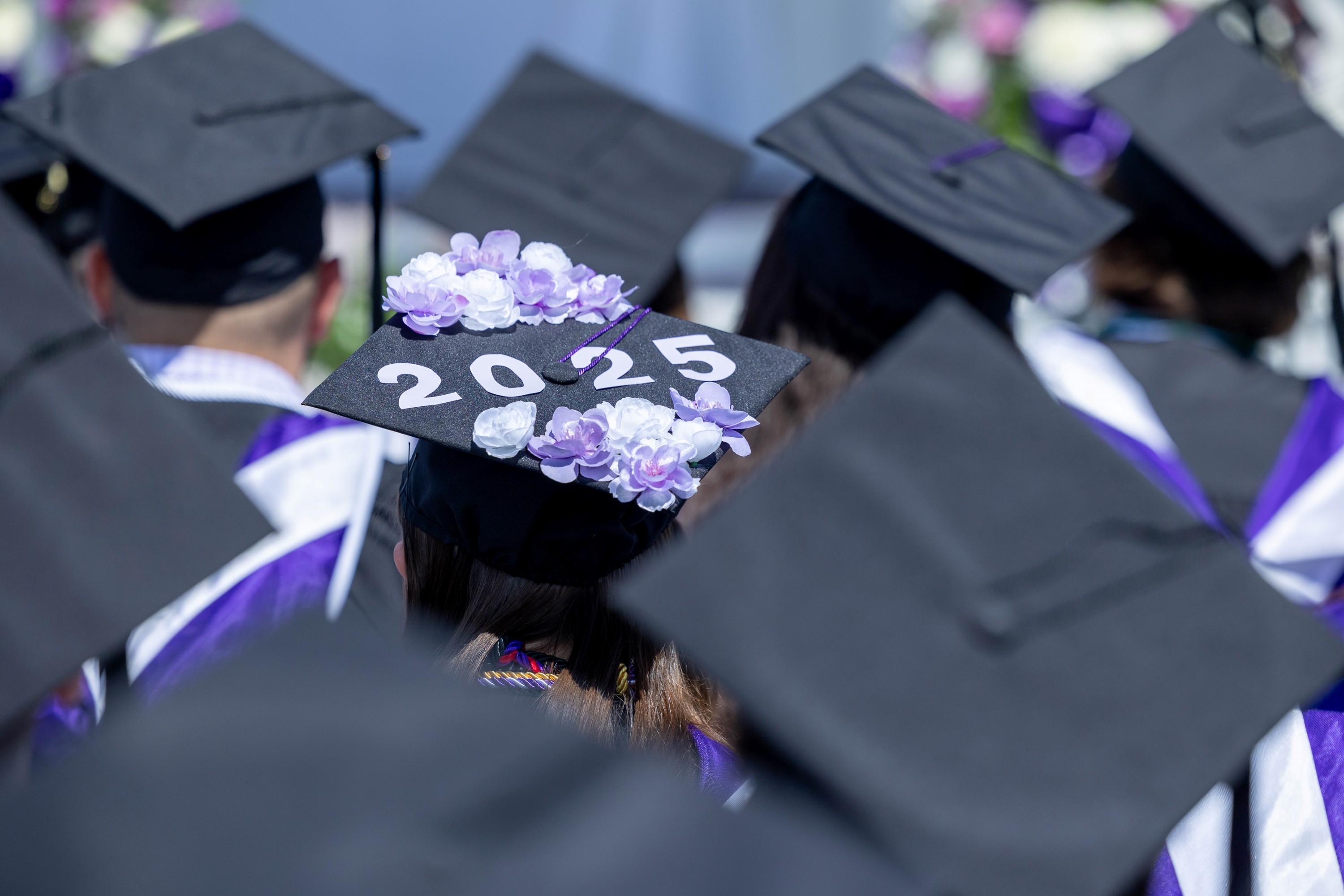 Graduation hat with purple flowers and 2025