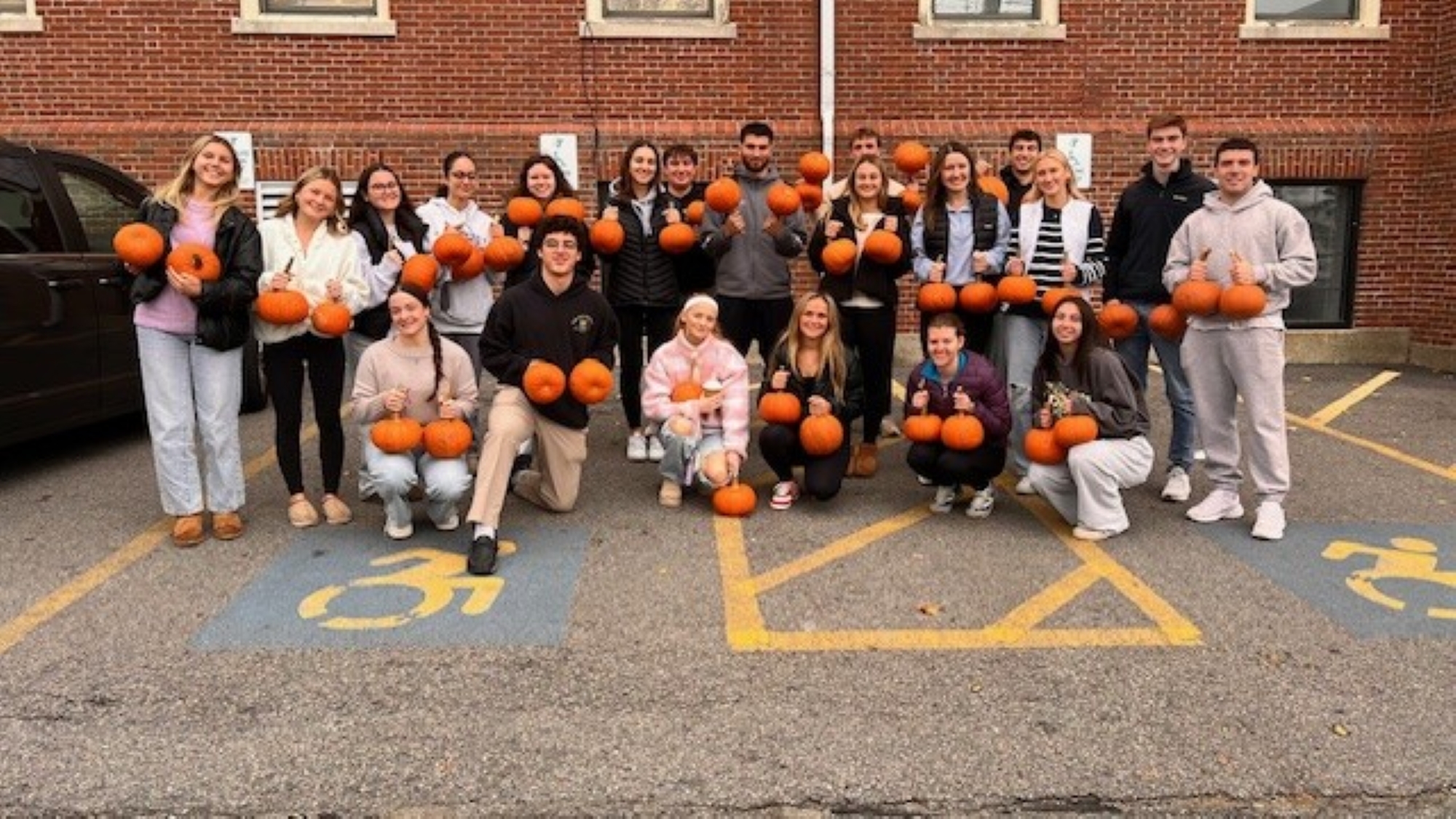 Students holding pumpkins