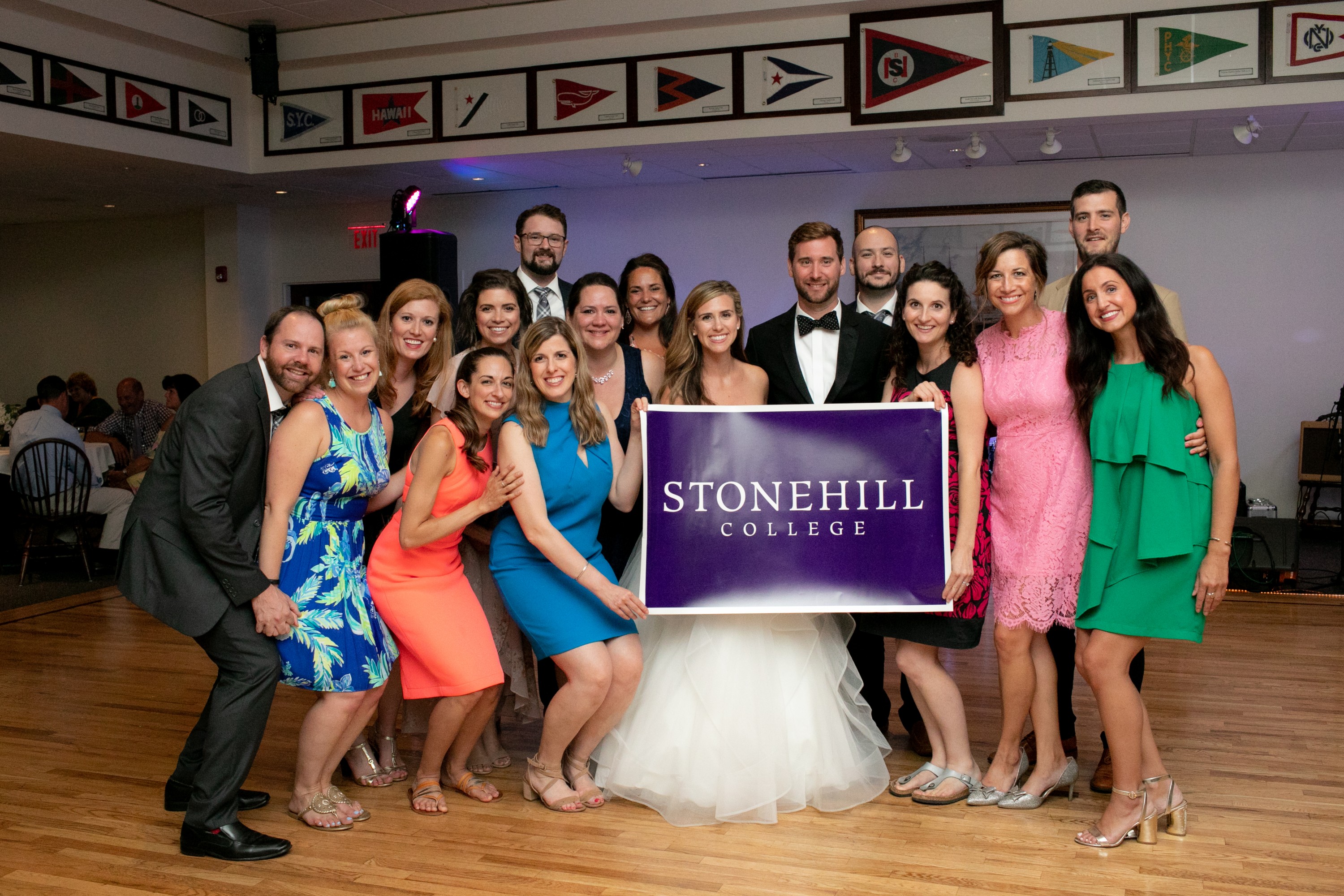 wedding party with Stonehill banner